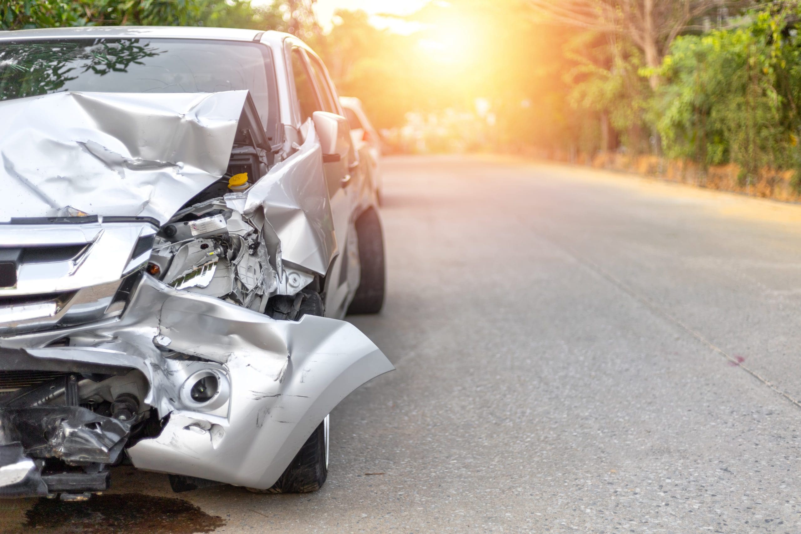 Front of light gray color car with pick up have big damaged and broken by accident on road in morning time can not drive any more park for wait insurance officer. With copy space for text or design Auto Accident